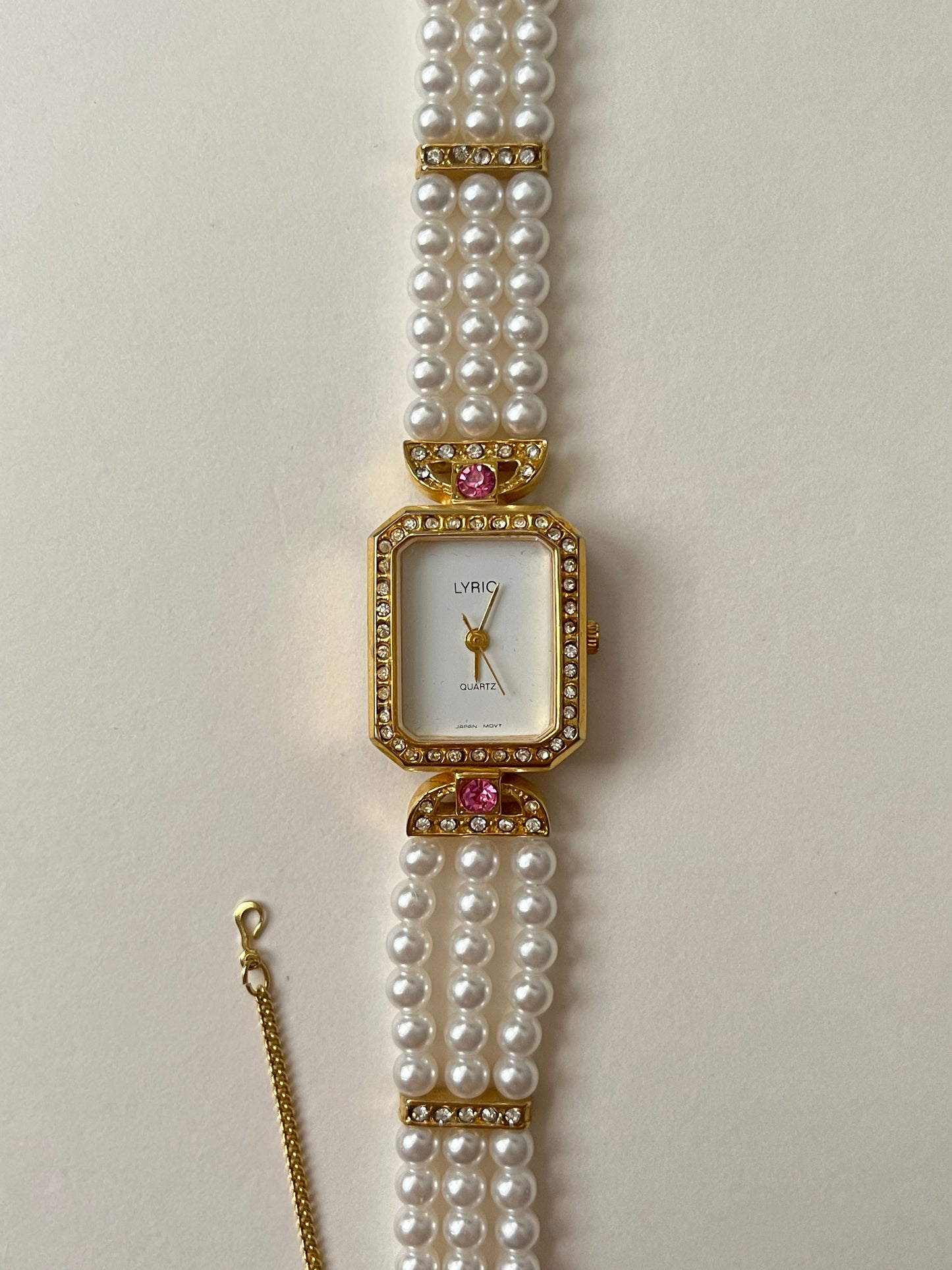 Gorgeous Faux Pearl Gold Tone Watch with Rectangular Dial and White and Pink Stones Accent