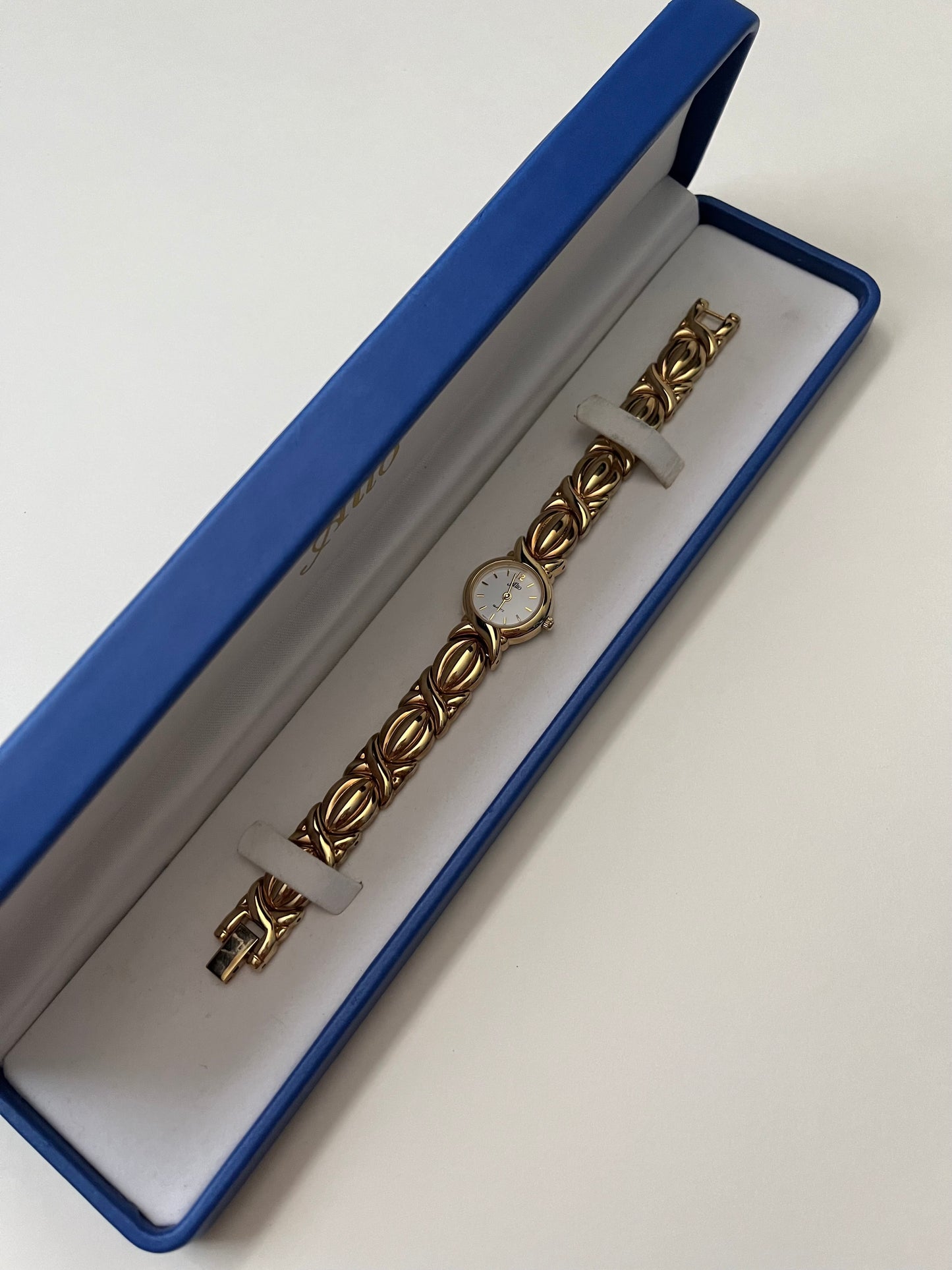 A Classic and Ornate Gold Tone Watch with Round Dial