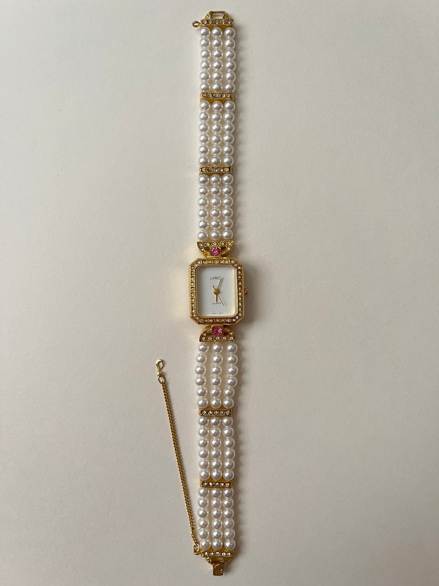 Gorgeous Faux Pearl Gold Tone Watch with Rectangular Dial and White and Pink Stones Accent