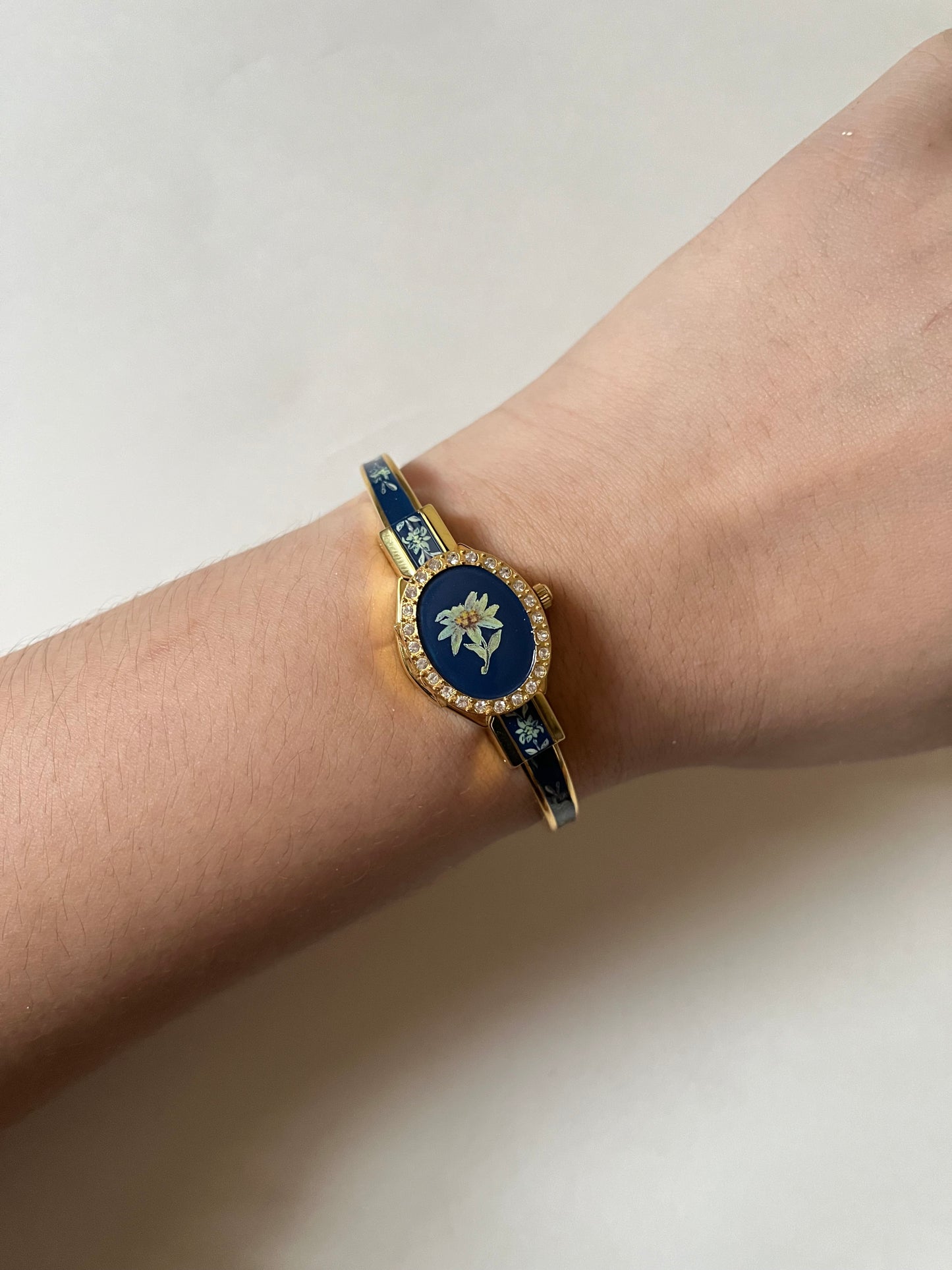 Beautiful Gold Tone Open Cuff Peekaboo Swiss Watch with Navy Floral Enameled Bracelet