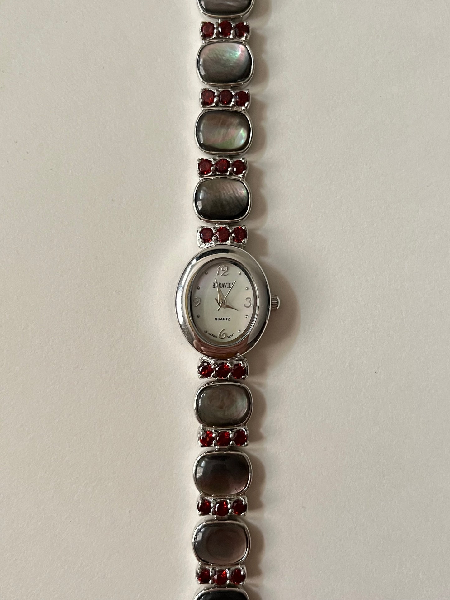 Captivating Silver Tone Watch with Red Stones and Gray Abalone Accents