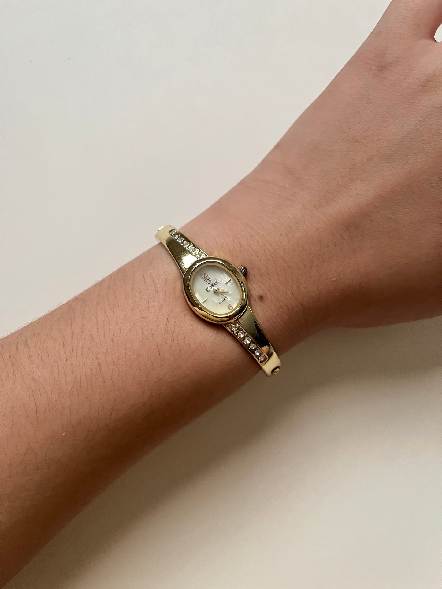 Gold Tone Cuff Watch with Oval Dial and Rhinestones Accent