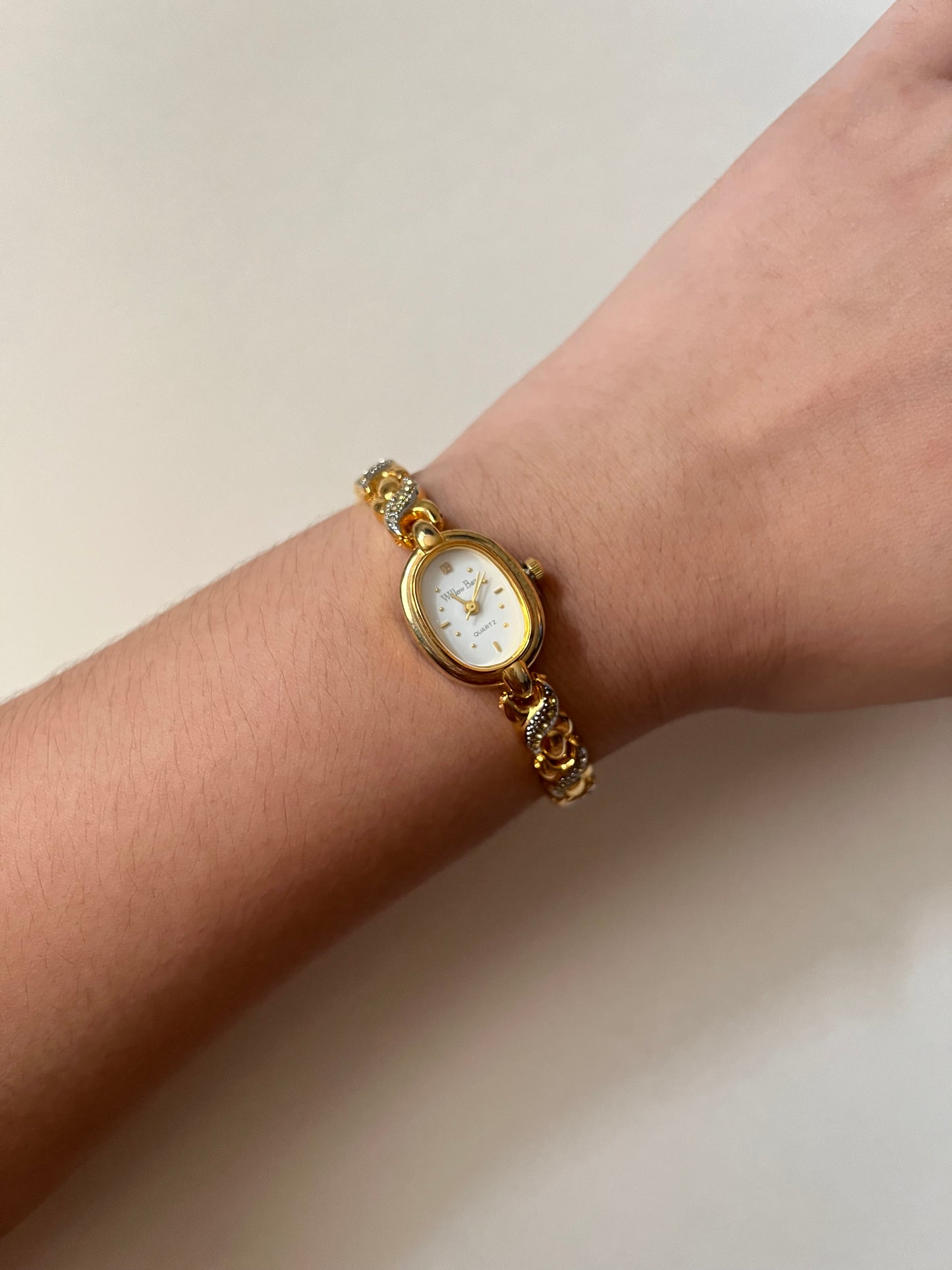 Dainty Gold Tone Watch with Oval Dial and Rhinestones Accent