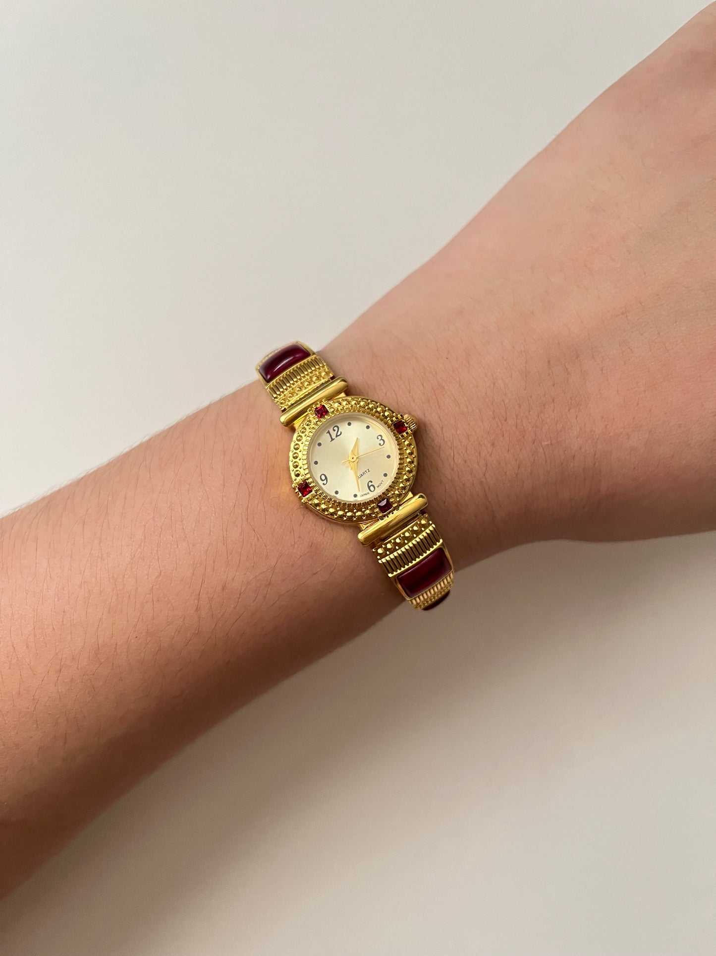 Gorgeous Gold Tone Expansion Watch with Red Gems Accent