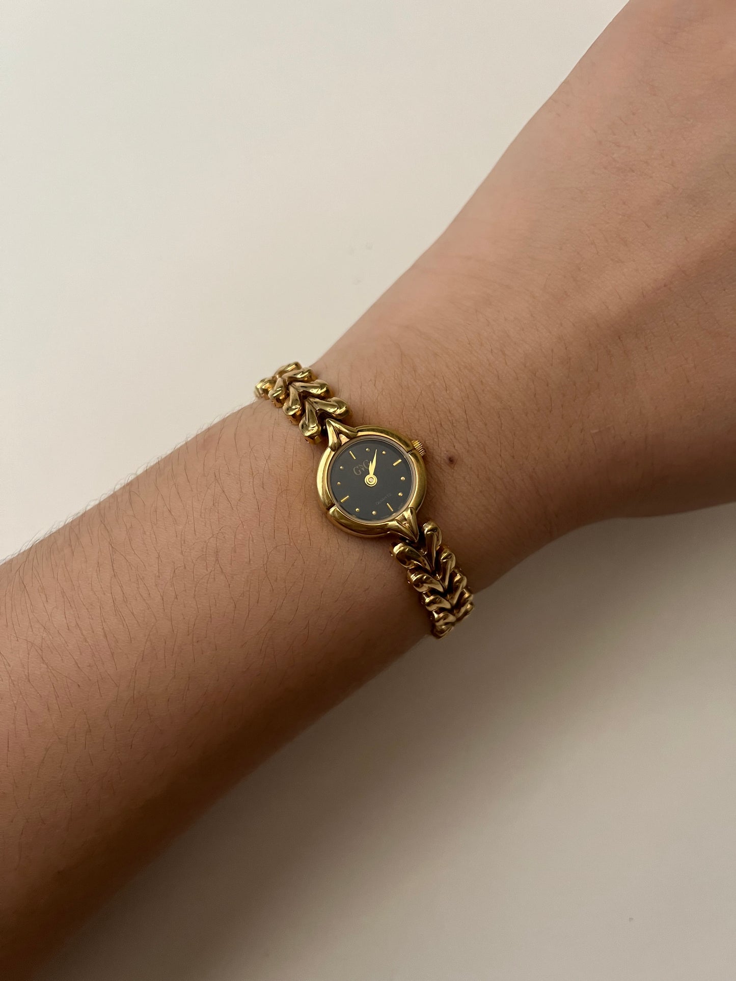 Gold Tone Watch with Black Round Dial