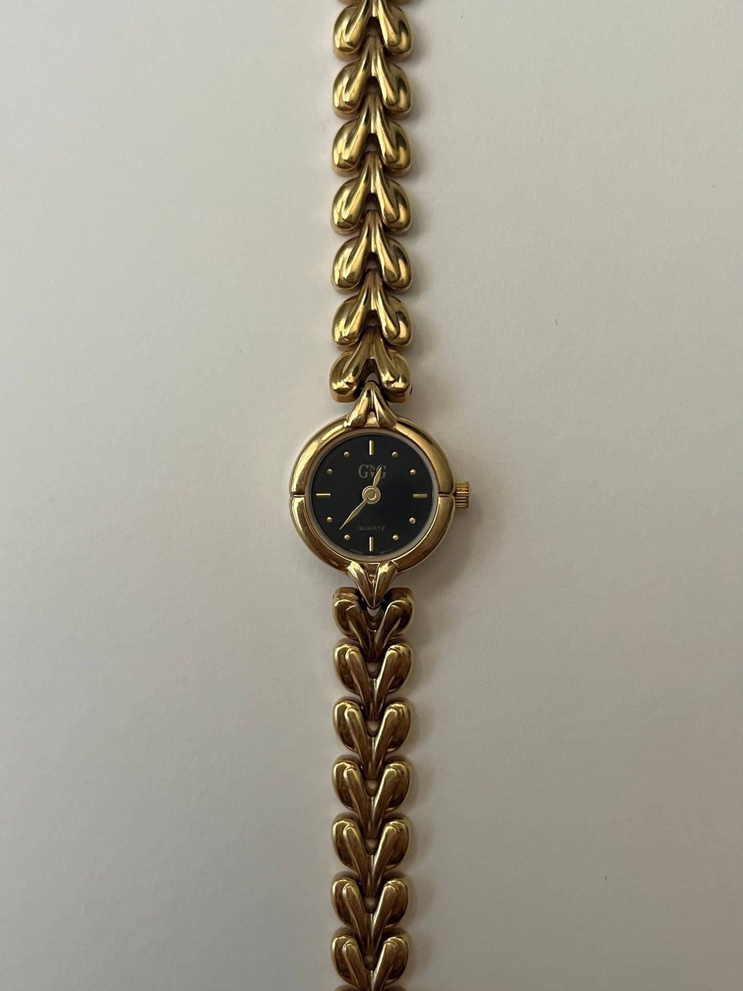 Gold Tone Watch with Black Round Dial