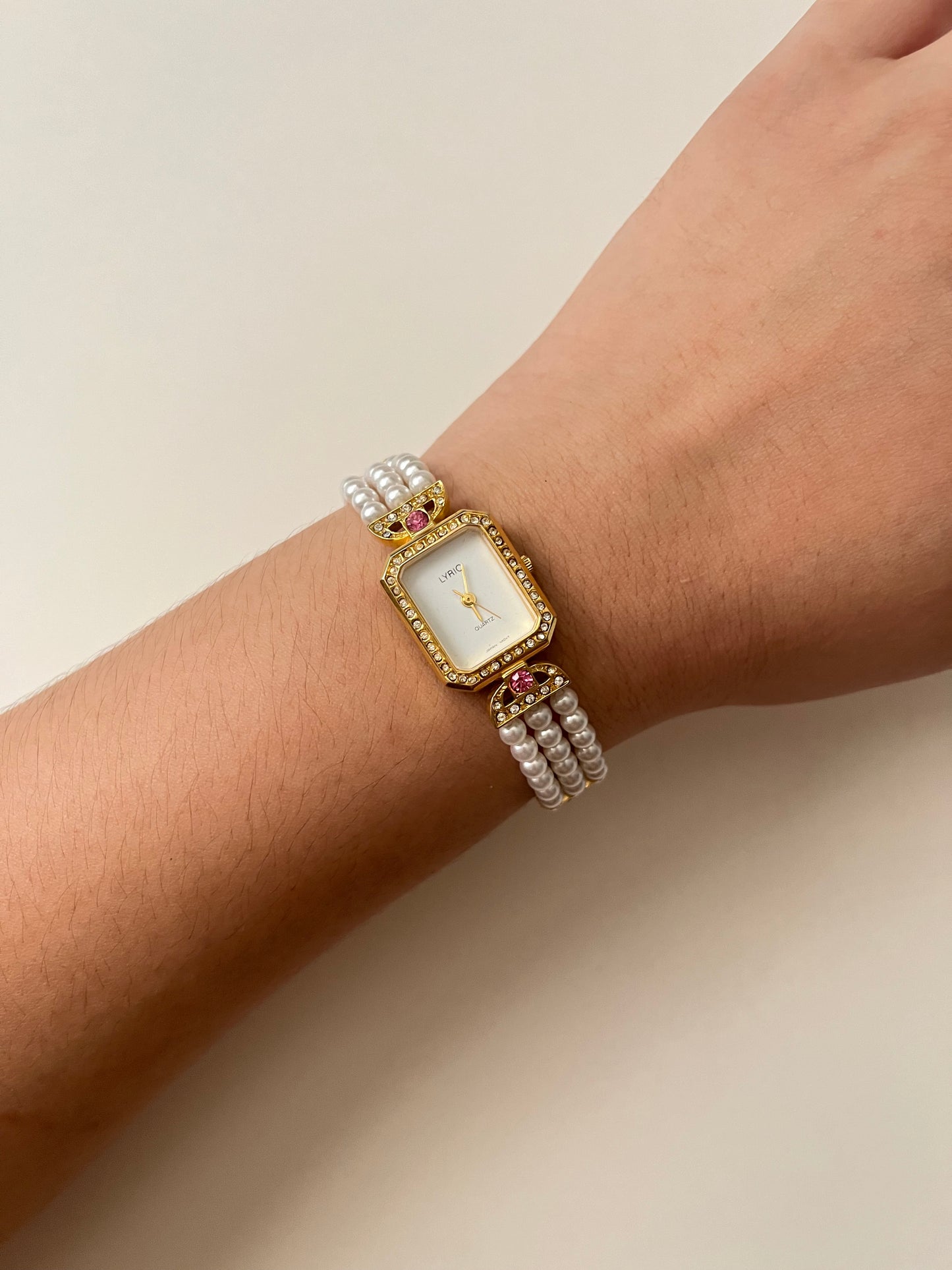 Gorgeous Faux Pearl Gold Tone Watch with Rectangular Dial and White and Pink Stones Accent