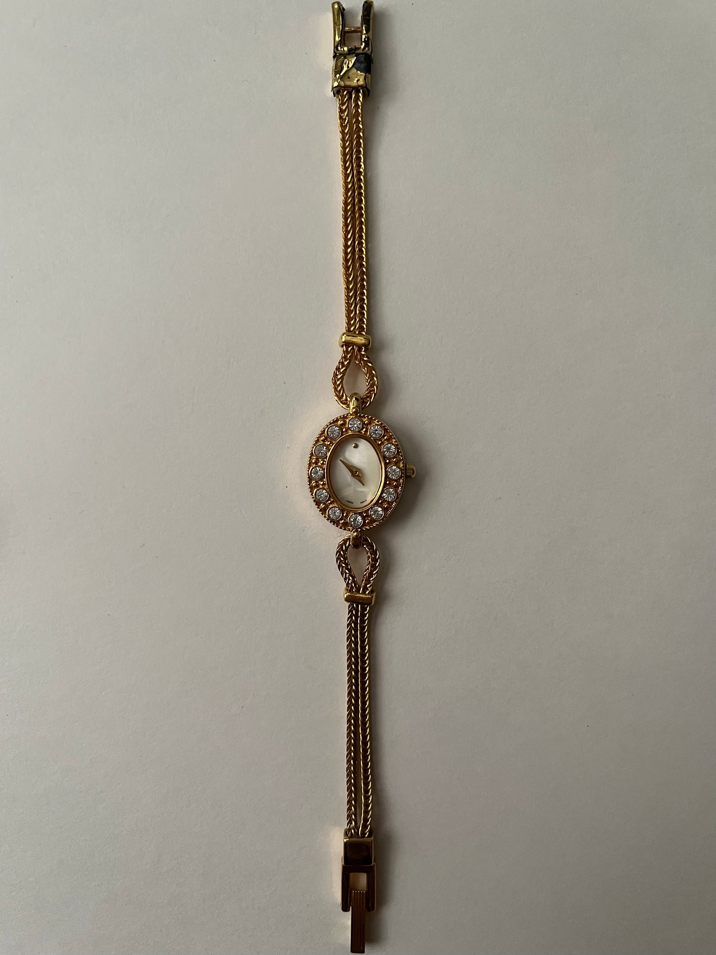 Elegant Dainty Gold Tone Tennis Bracelet Style Watch with Bejeweled Oval Dial