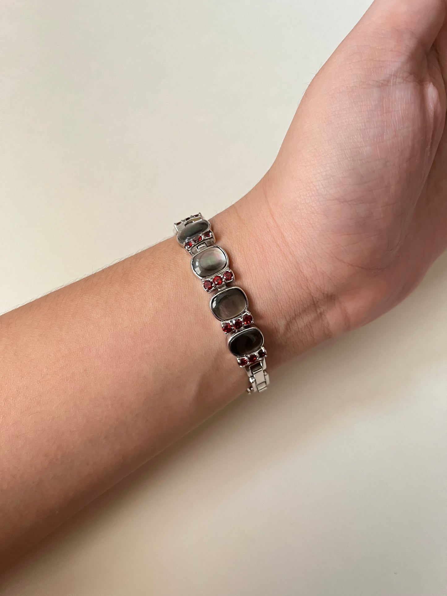 Captivating Silver Tone Watch with Red Stones and Gray Abalone Accents