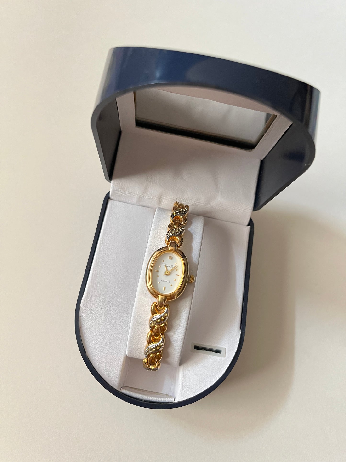 Dainty Gold Tone Watch with Oval Dial and Rhinestones Accent