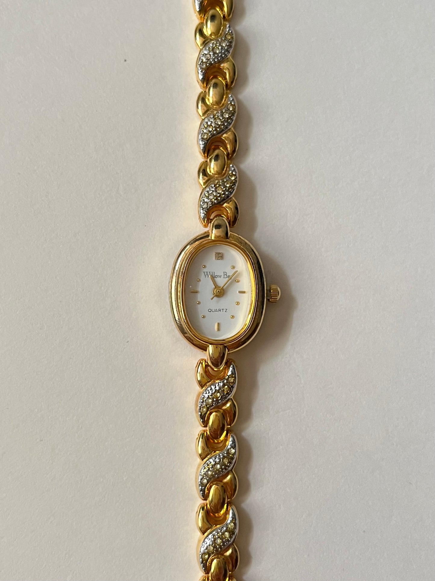 Dainty Gold Tone Watch with Oval Dial and Rhinestones Accent