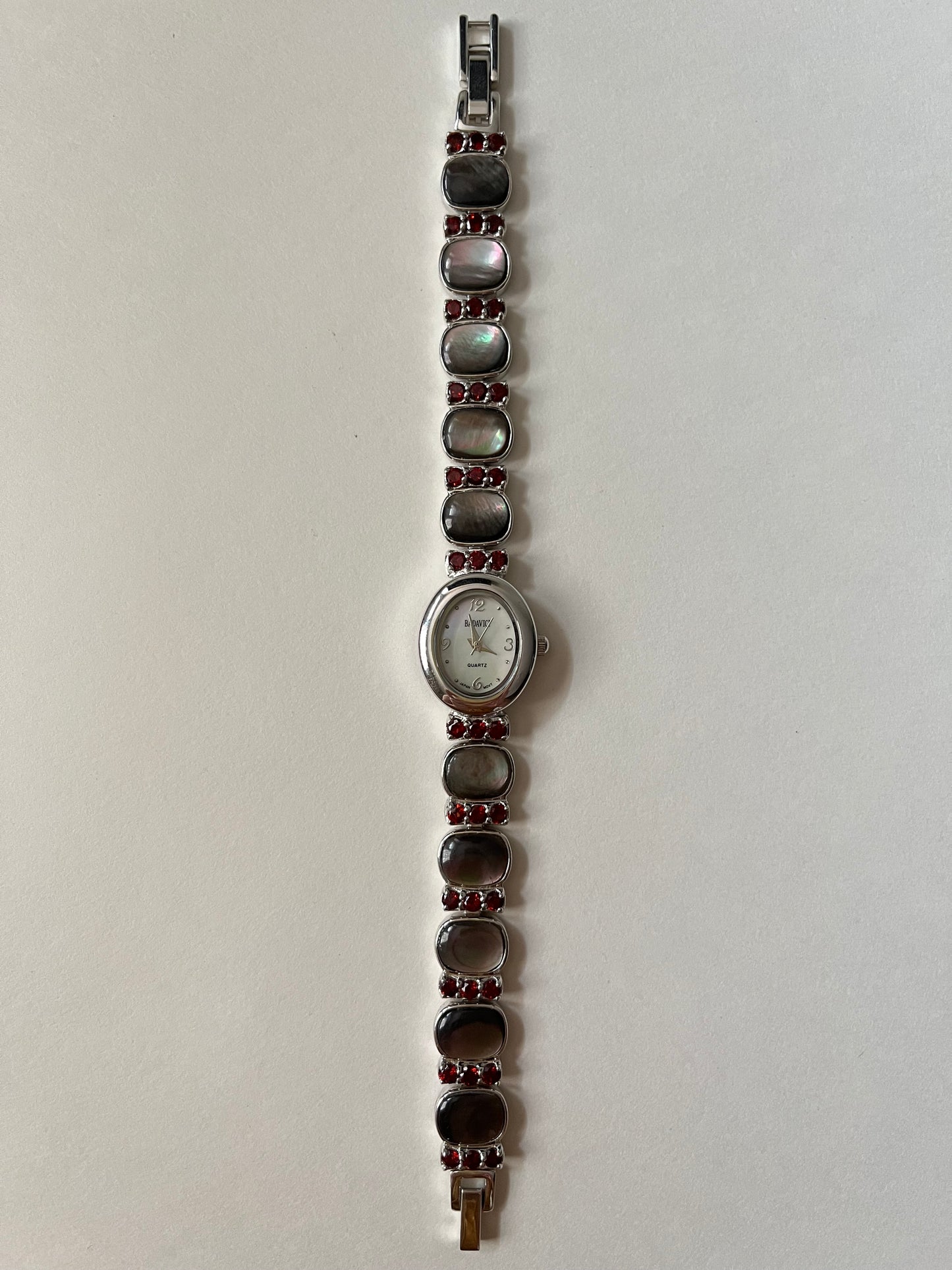 Captivating Silver Tone Watch with Red Stones and Gray Abalone Accents