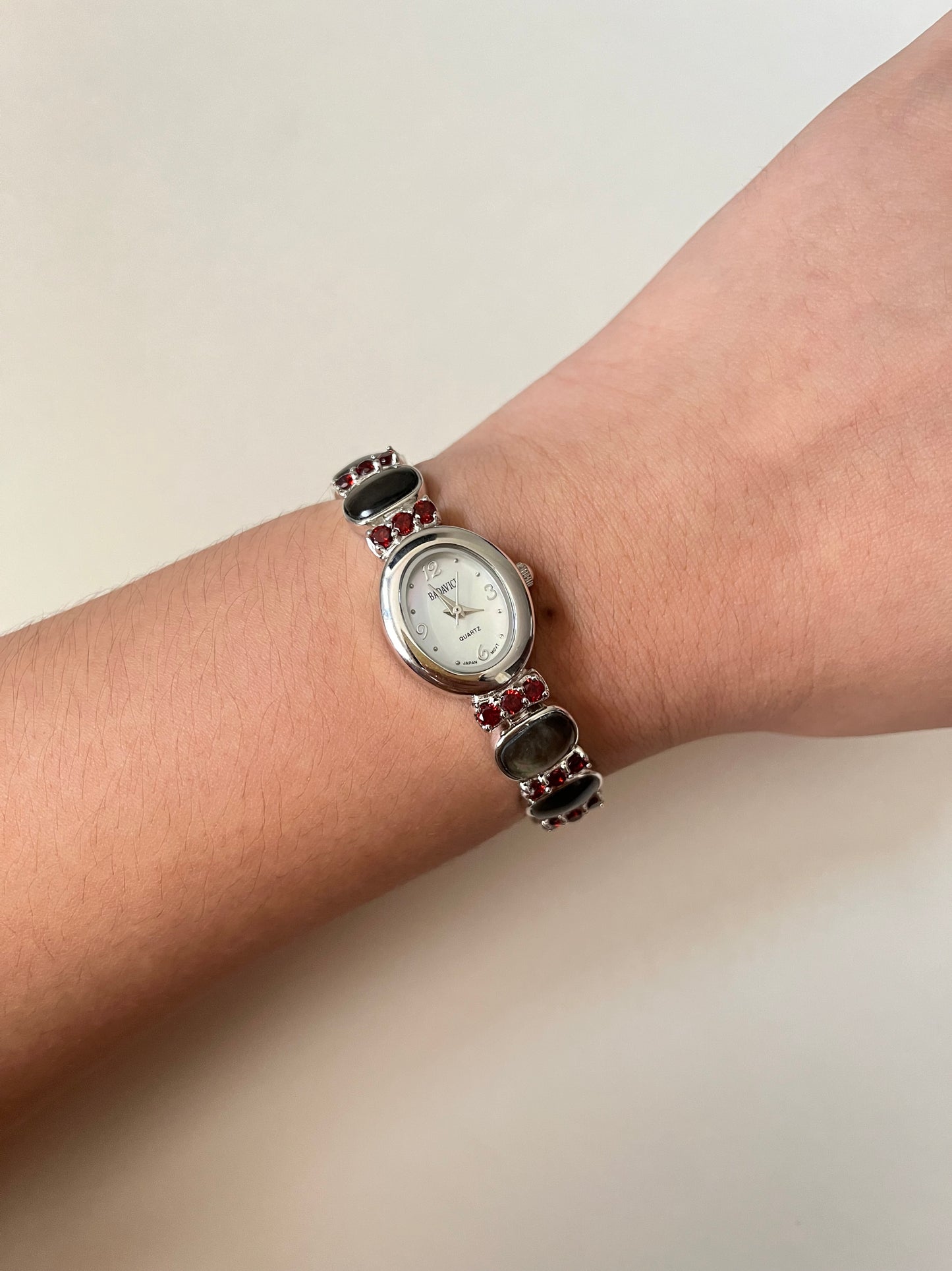 Captivating Silver Tone Watch with Red Stones and Gray Abalone Accents