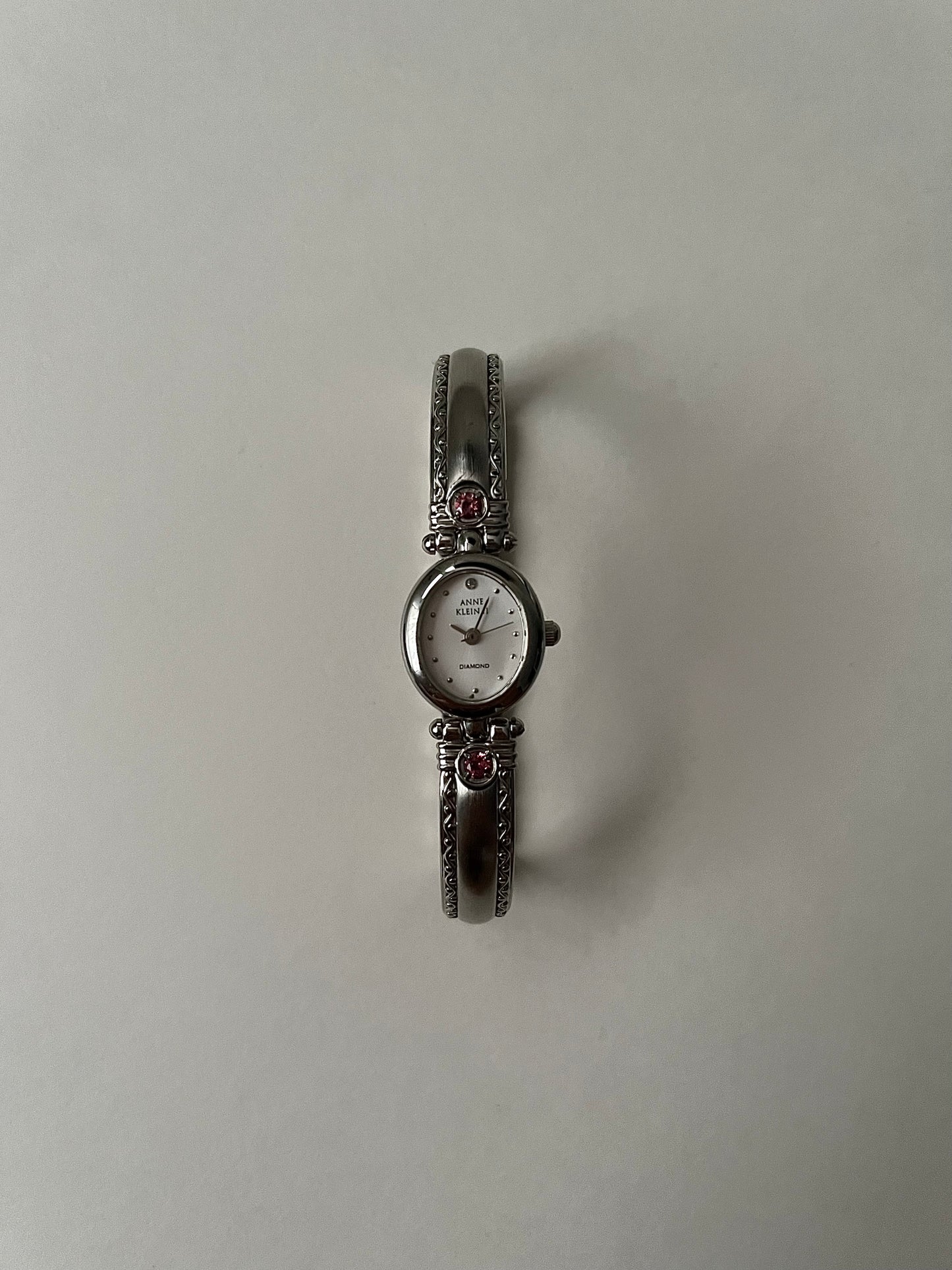 Silver Tone Anne Klein Cuff Watch with Oval Dial and Pink Stones Accent
