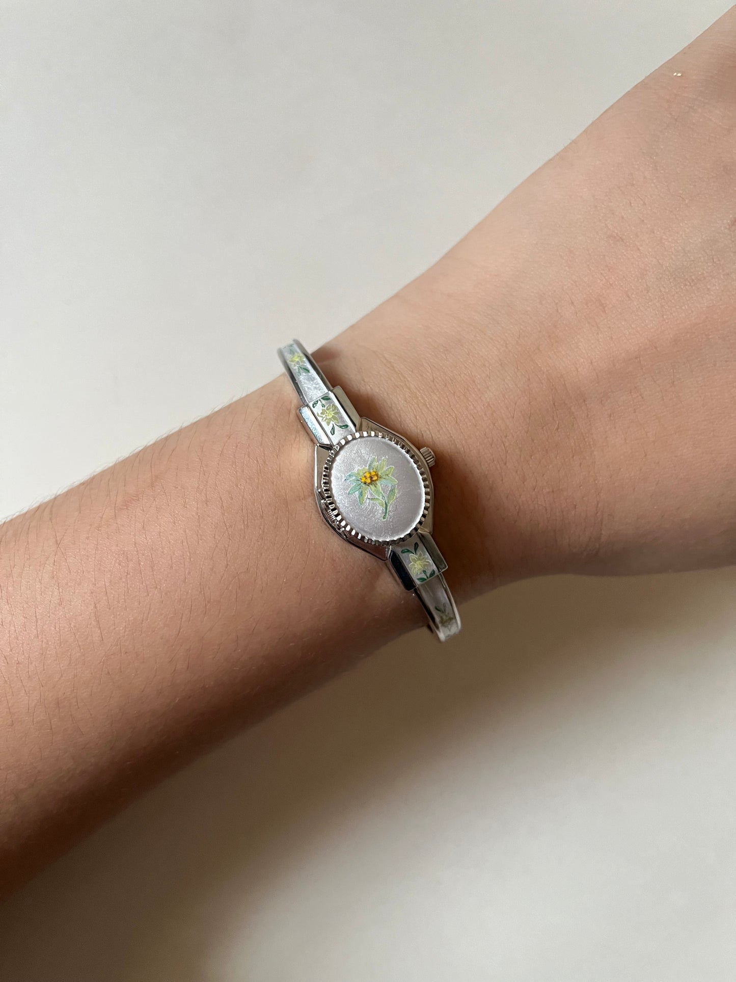Beautiful Silver Tone Open Cuff Peekaboo Swiss Watch with White Floral Enameled Bracelet
