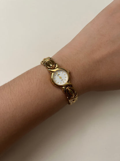 A Classic and Ornate Gold Tone Watch with Round Dial