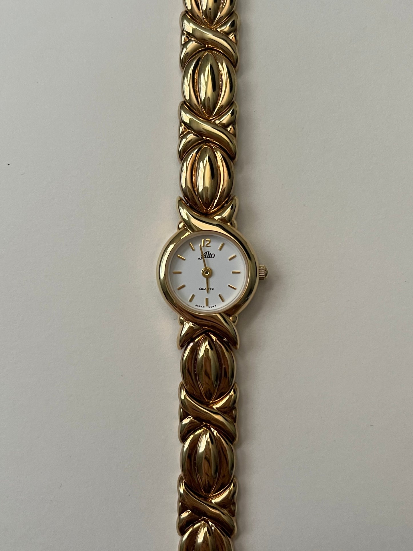 A Classic and Ornate Gold Tone Watch with Round Dial