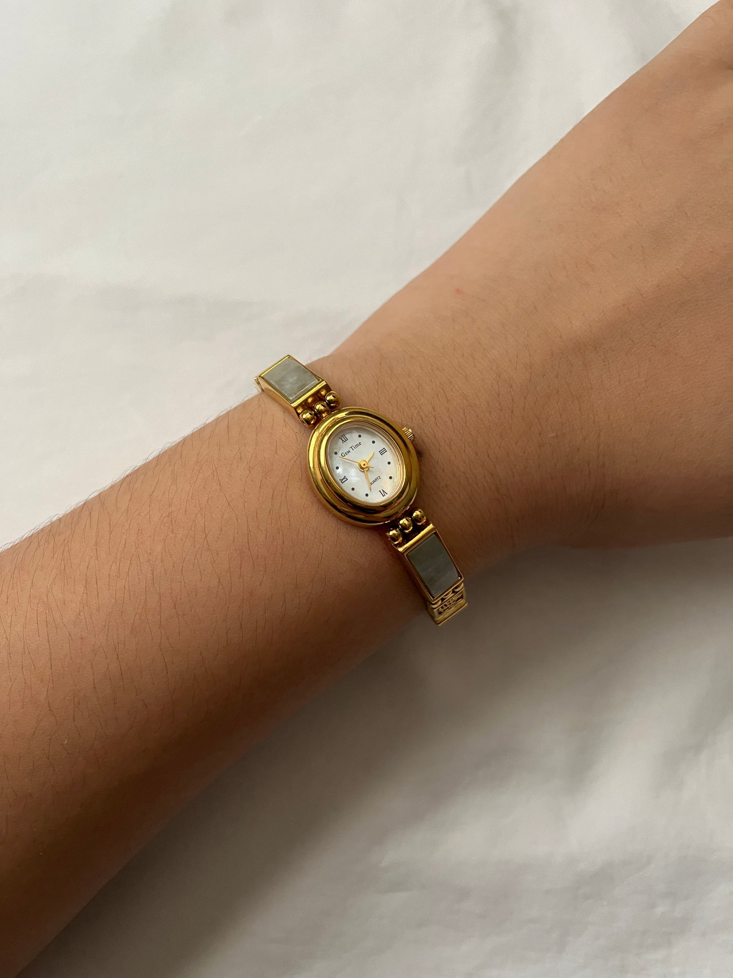 Stunning Gold Tone Watch with Oval Dial and Jade Inlay Band