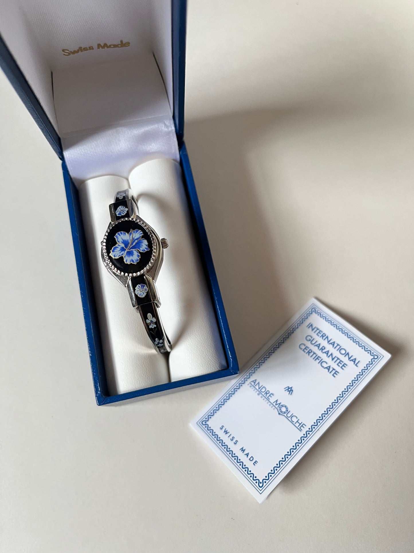 Beautiful Silver Tone Open Cuff Peekaboo Swiss Watch with Black Floral Enameled Bracelet