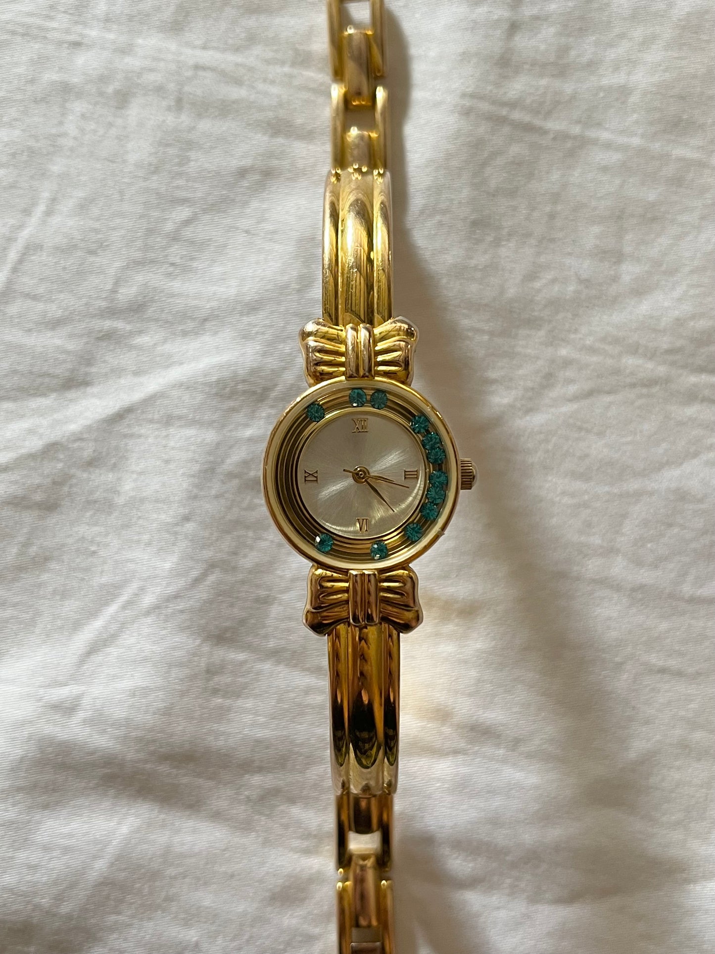 Coquette Style Gold Tone Half Cuff Watch with Dancing Green Crystals