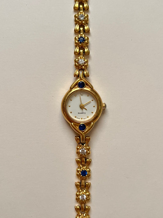 Adorable Gold Tone Watch with Floral Band Design and Blue Stones Accent