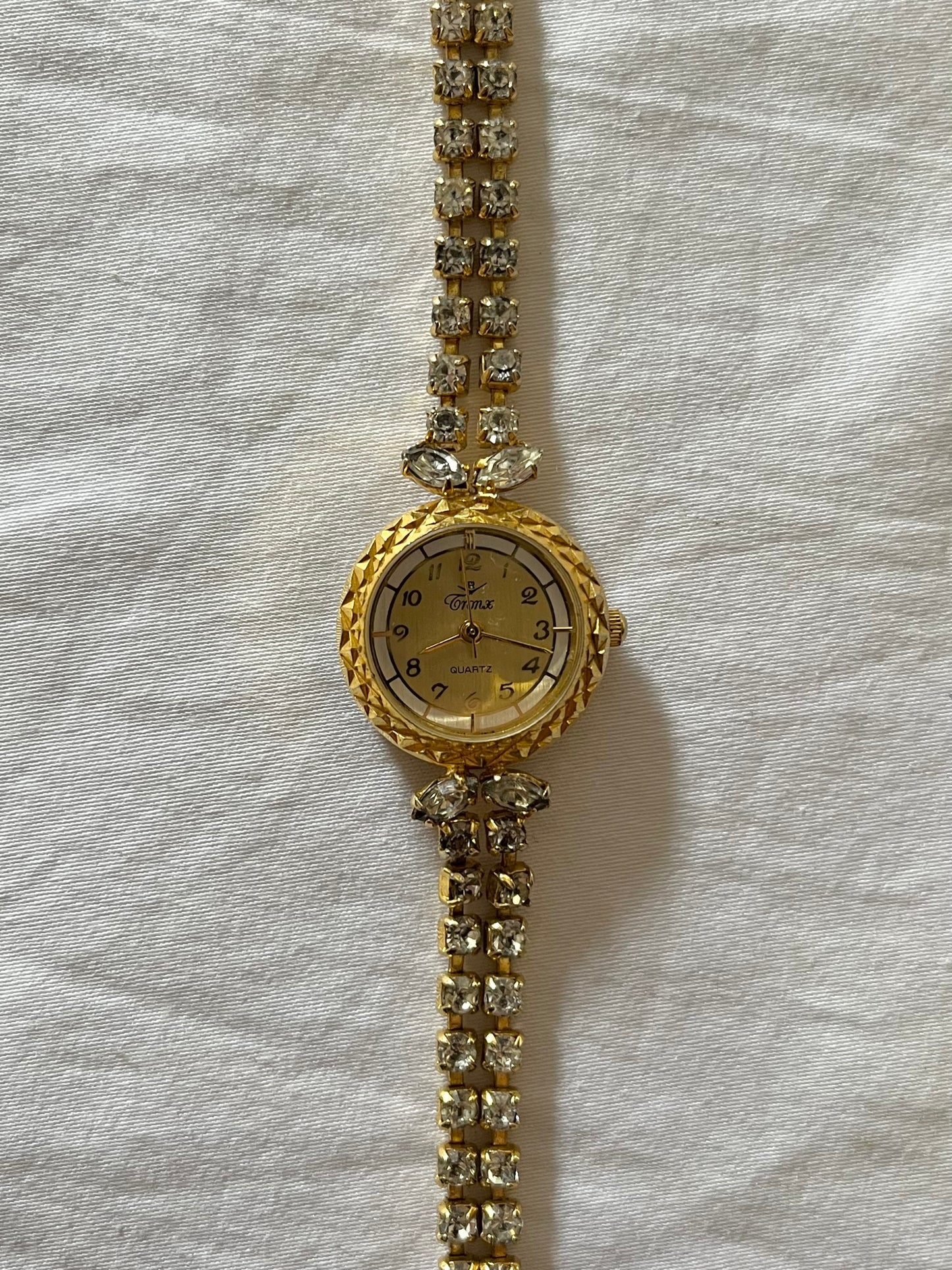 Elegant Gold Tone Watch with Crystals Encrusted Band