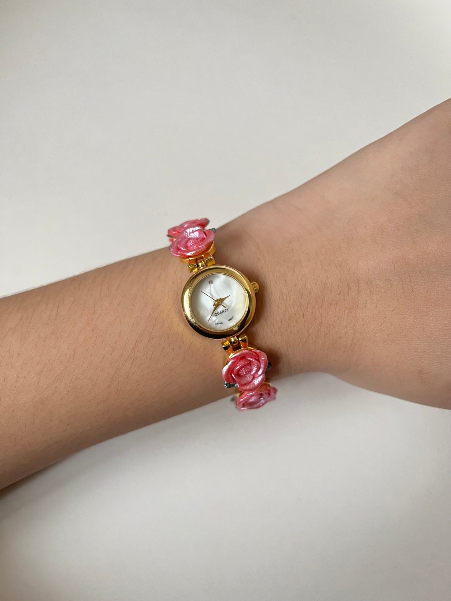 Pretty Gold Tone Watch with Round Dial and Pink Rose Links