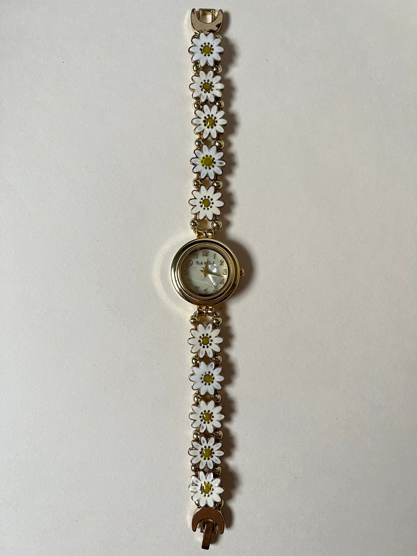 Adorable Gold Tone Sliding Watch with Round Dial and White Daisies as Links