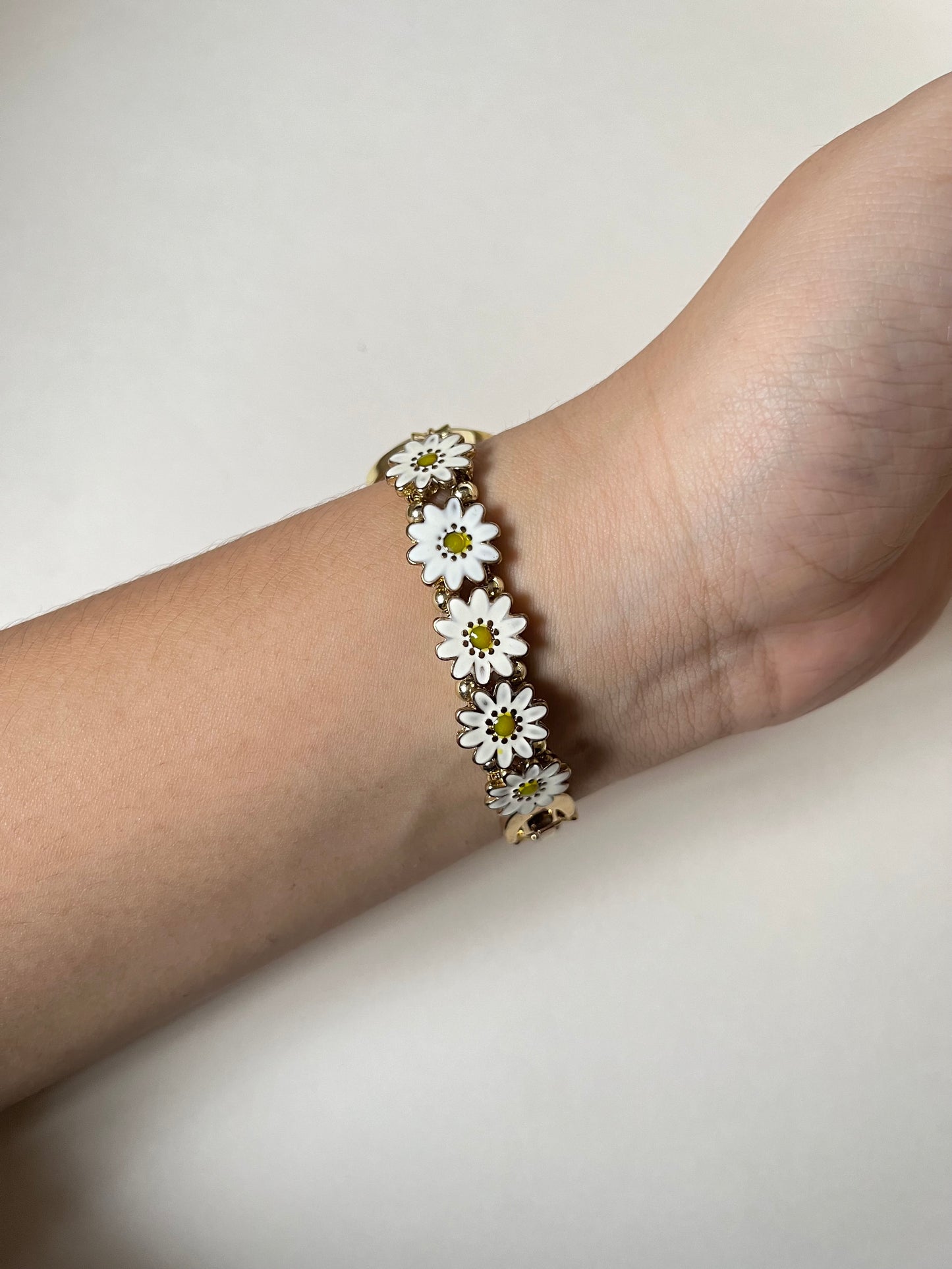 Adorable Gold Tone Sliding Watch with Round Dial and White Daisies as Links