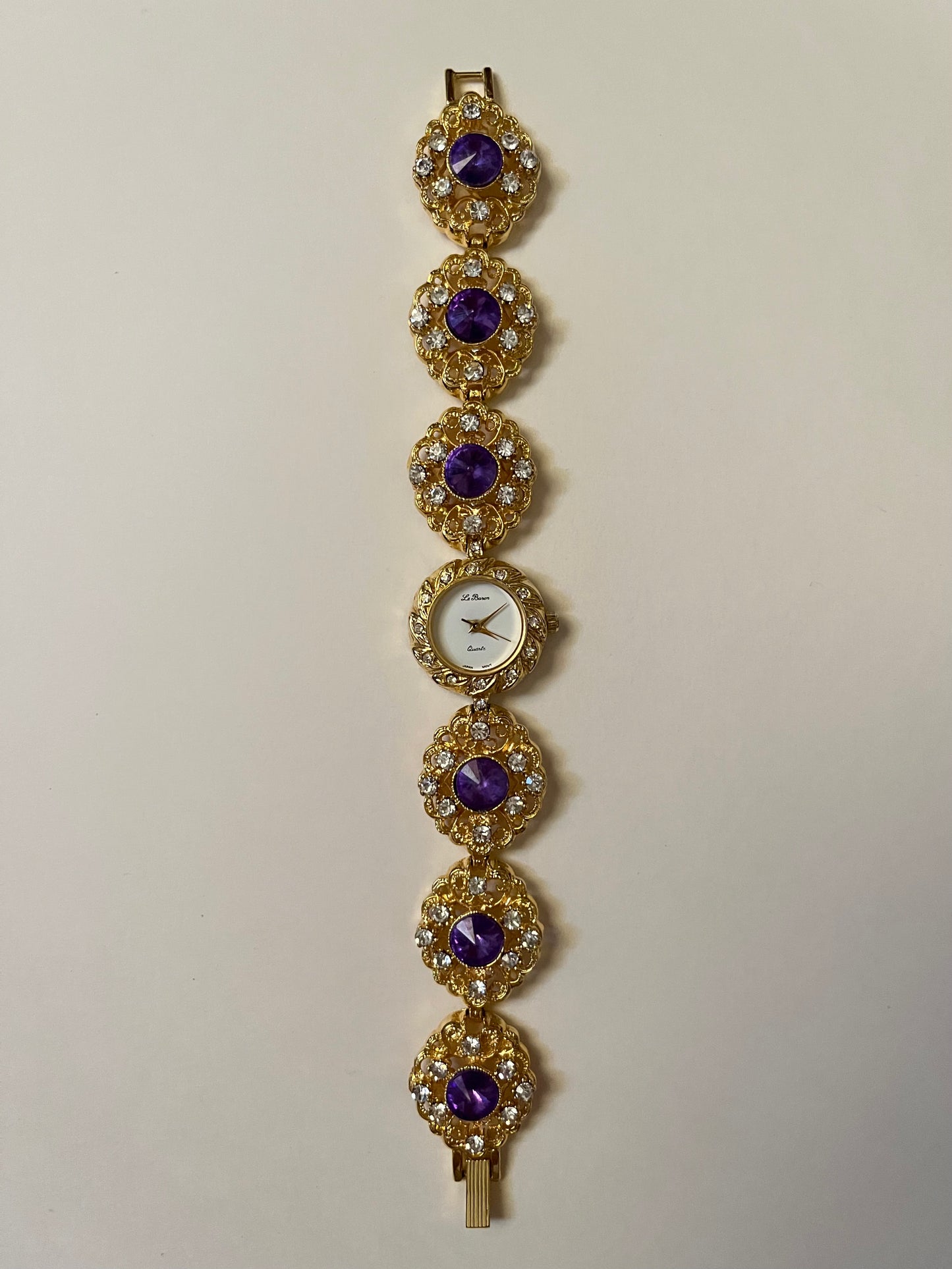 Extremely Rare and Breathtaking Gold Tone Watch with Ornate Band Design and Purple and Pink Stones Accent
