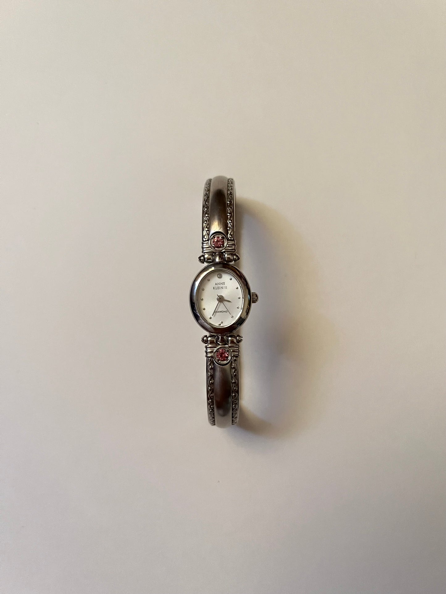 Silver Tone Anne Klein Cuff Watch with Oval Dial and Pink Stones Accent