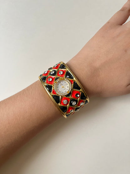 Striking Gold Tone Chunky Cuff Watch with Red and Black Checkerboard Design