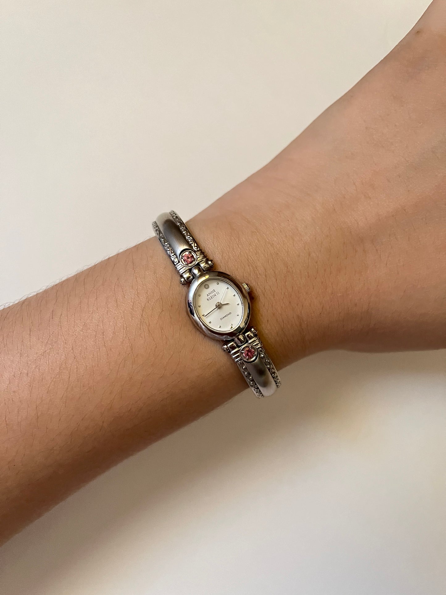 Silver Tone Anne Klein Cuff Watch with Oval Dial and Pink Stones Accent