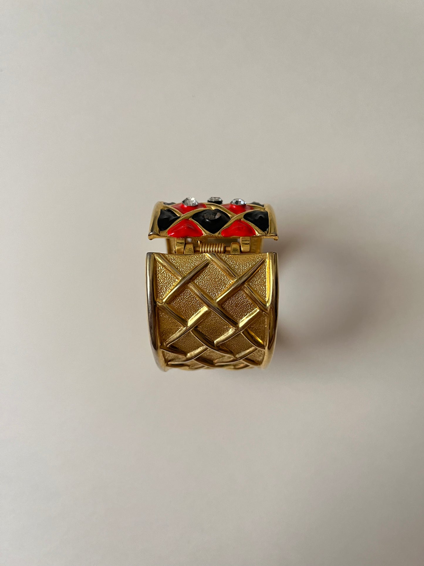 Striking Gold Tone Chunky Cuff Watch with Red and Black Checkerboard Design