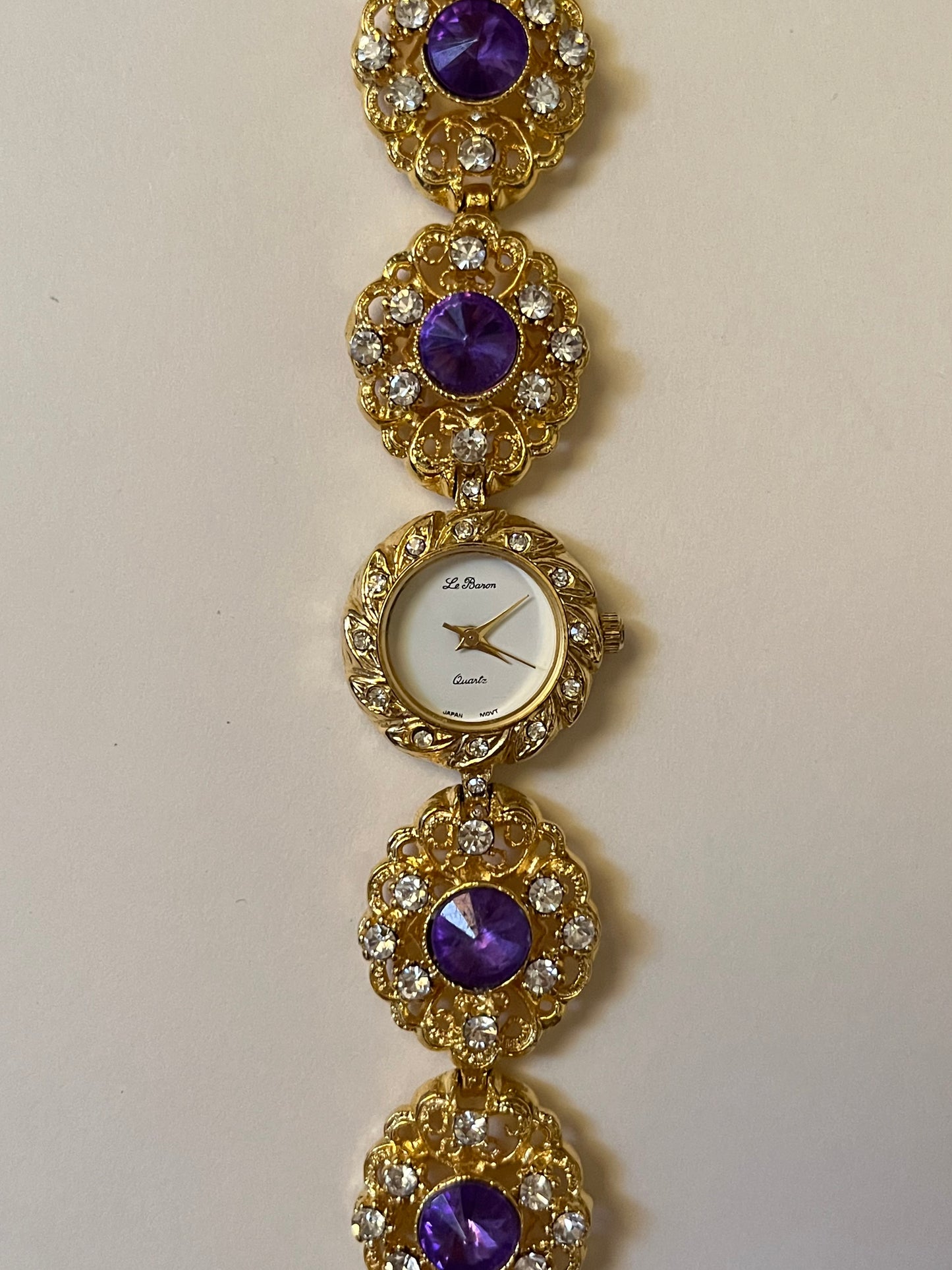 Extremely Rare and Breathtaking Gold Tone Watch with Ornate Band Design and Purple and Pink Stones Accent