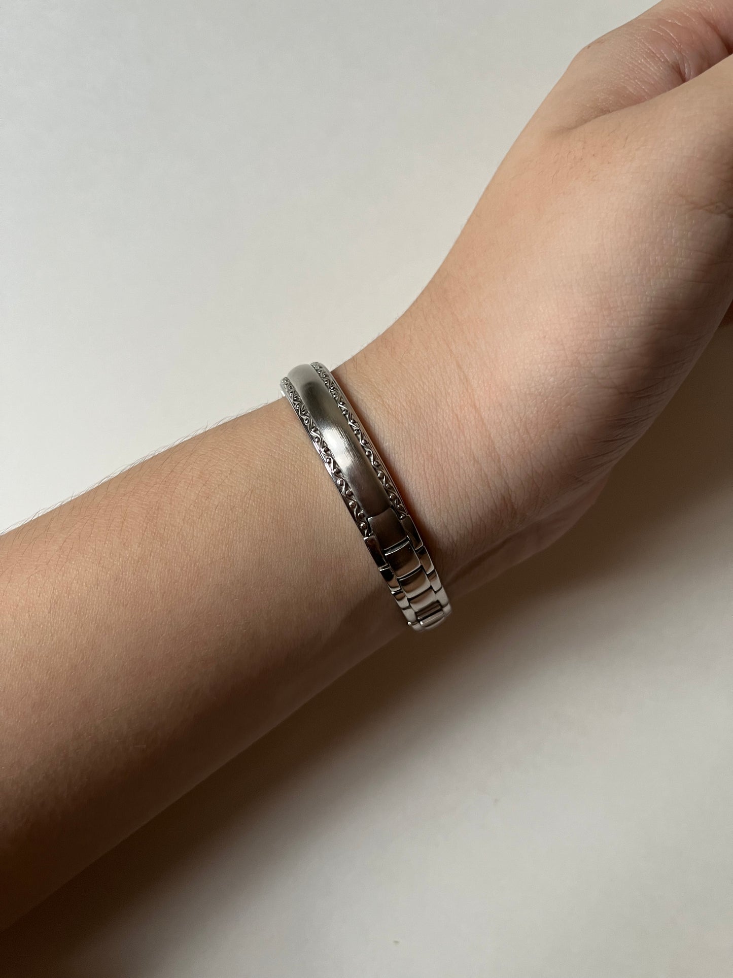 Silver Tone Anne Klein Cuff Watch with Oval Dial and Pink Stones Accent