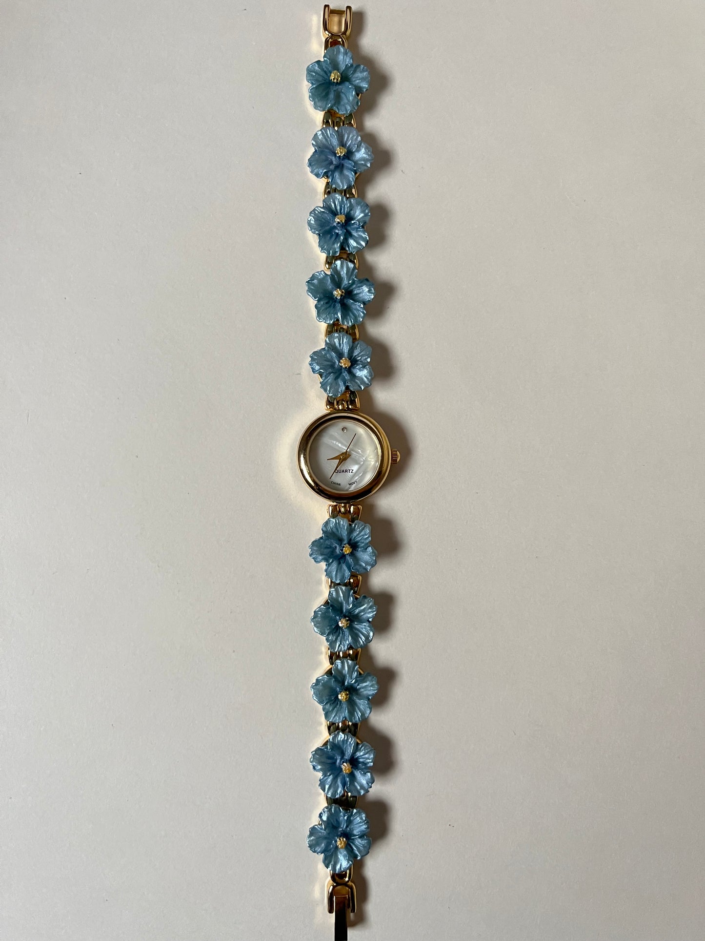 Adorable Gold Tone Watch with Round Dial and Blue Hibiscus Floral Links