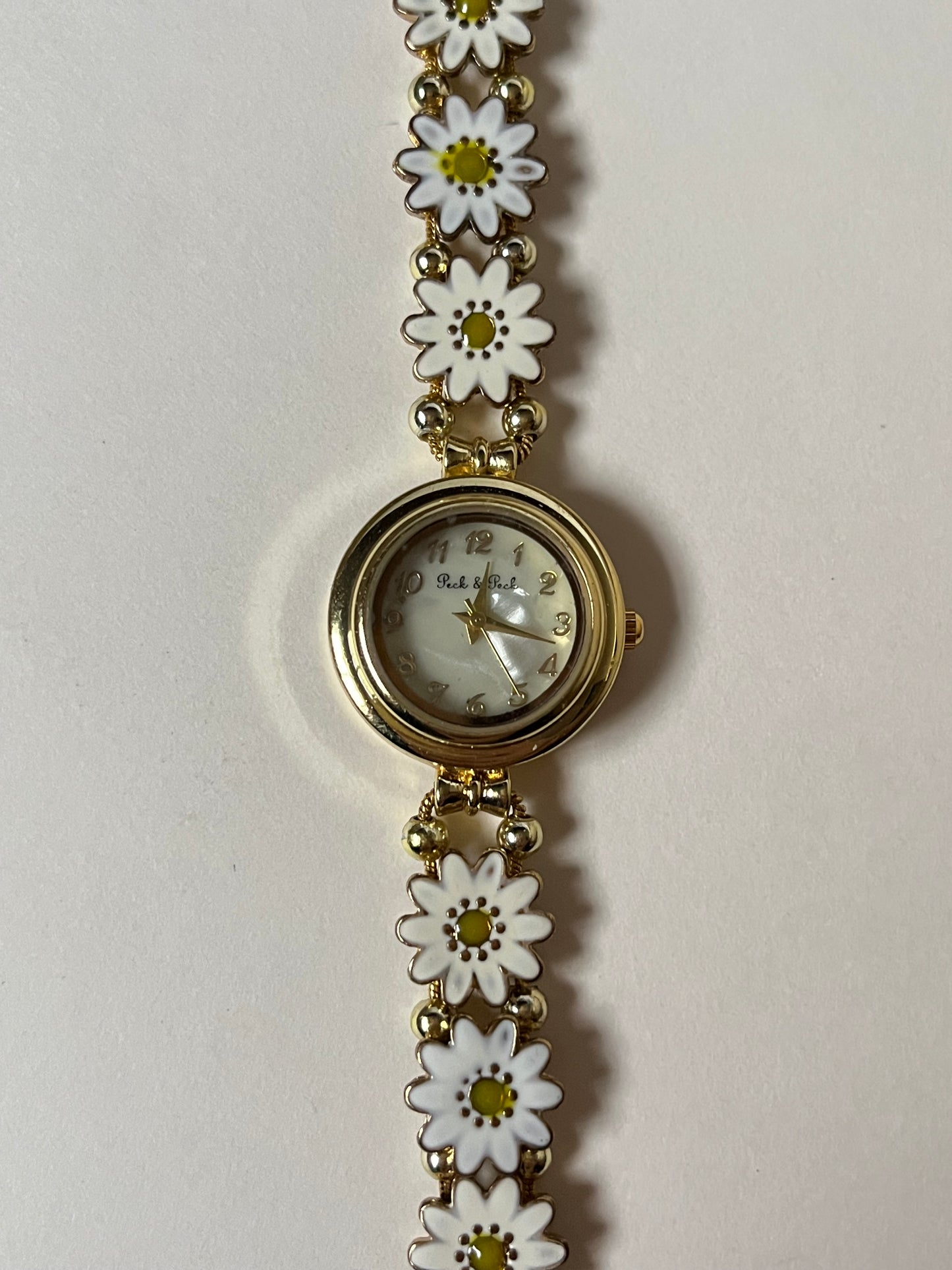 Adorable Gold Tone Sliding Watch with Round Dial and White Daisies as Links