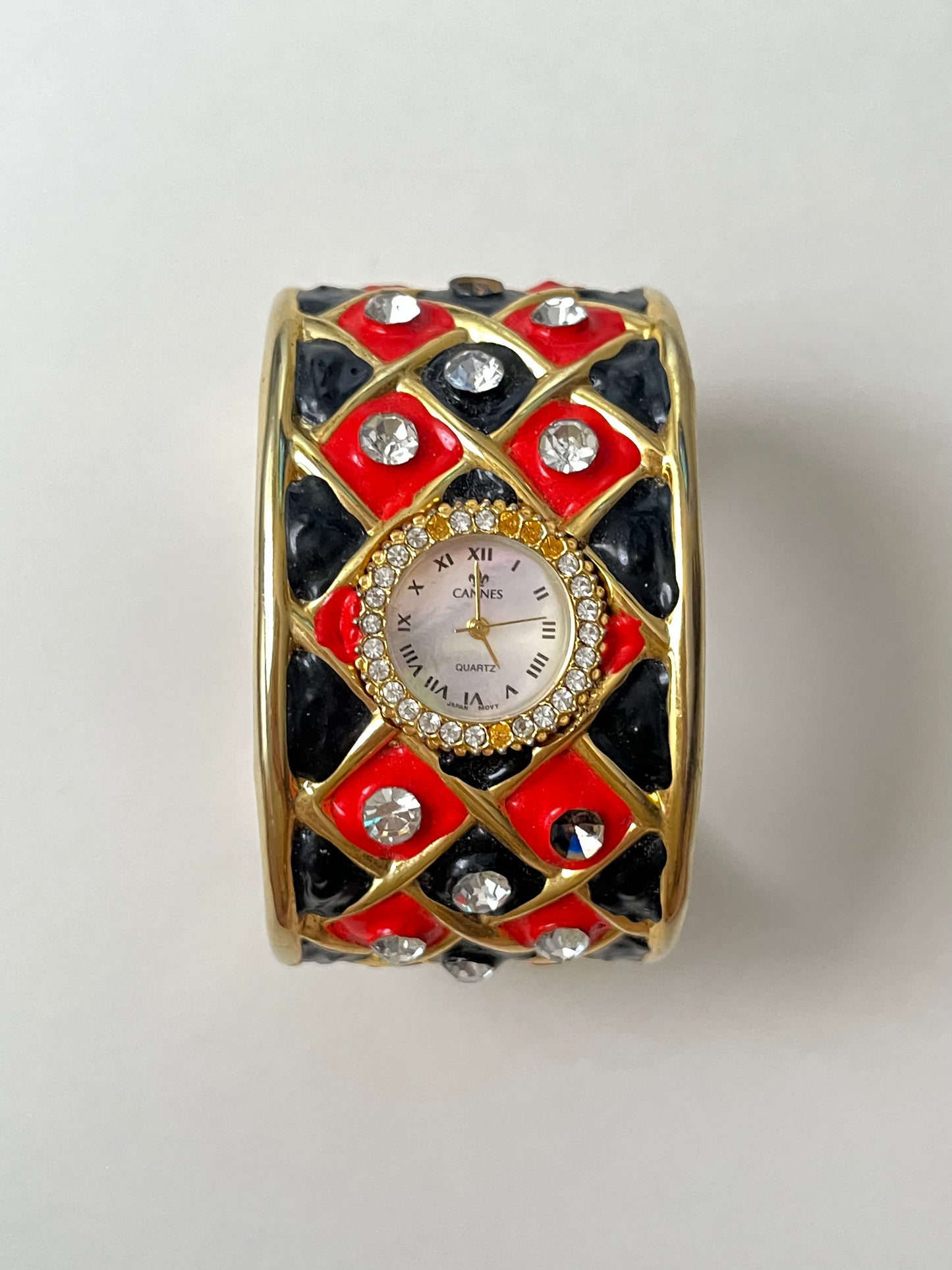 Striking Gold Tone Chunky Cuff Watch with Red and Black Checkerboard Design