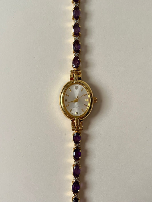 Gorgeous Gold Tone Tennis Bracelet Style Watch with Purple Stones Accent