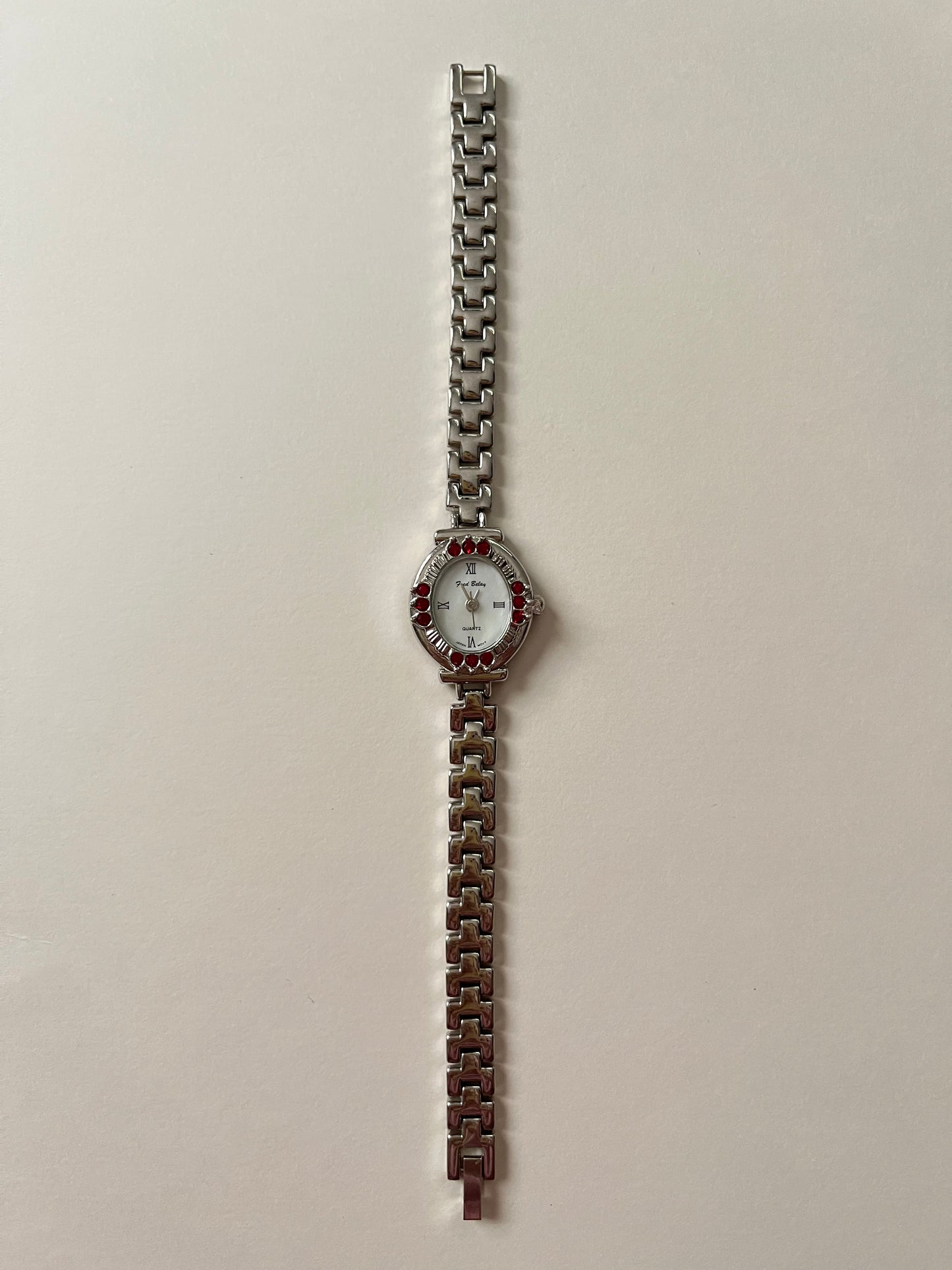 Beautiful Silver Tone Watch with Oval Dial and Gorgeous Red Gems Accent