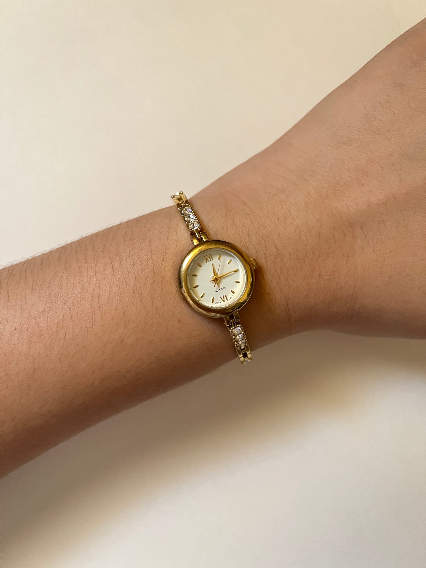 Dainty Gold Tone Watch with Round Dial and Rhinestones Accent