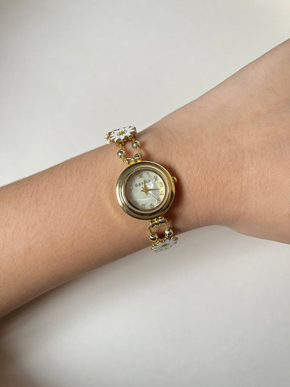 Adorable Gold Tone Sliding Watch with Round Dial and White Daisies as Links