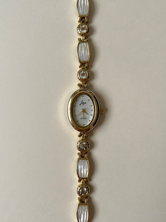 Adorable Gold Tone Watch with White Gems and Rhinestones Accent
