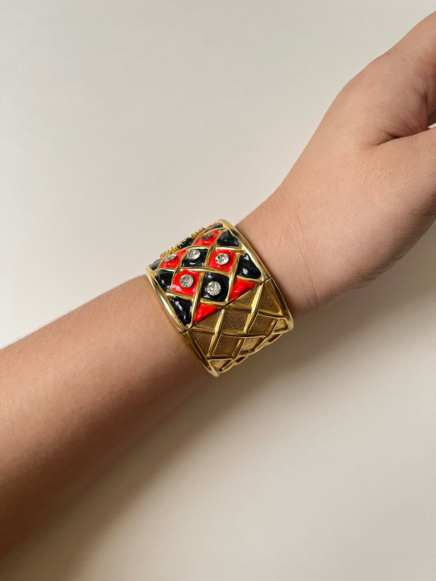 Striking Gold Tone Chunky Cuff Watch with Red and Black Checkerboard Design