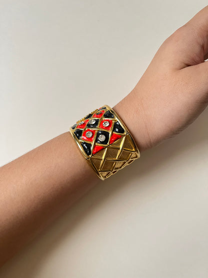 Striking Gold Tone Chunky Cuff Watch with Red and Black Checkerboard Design